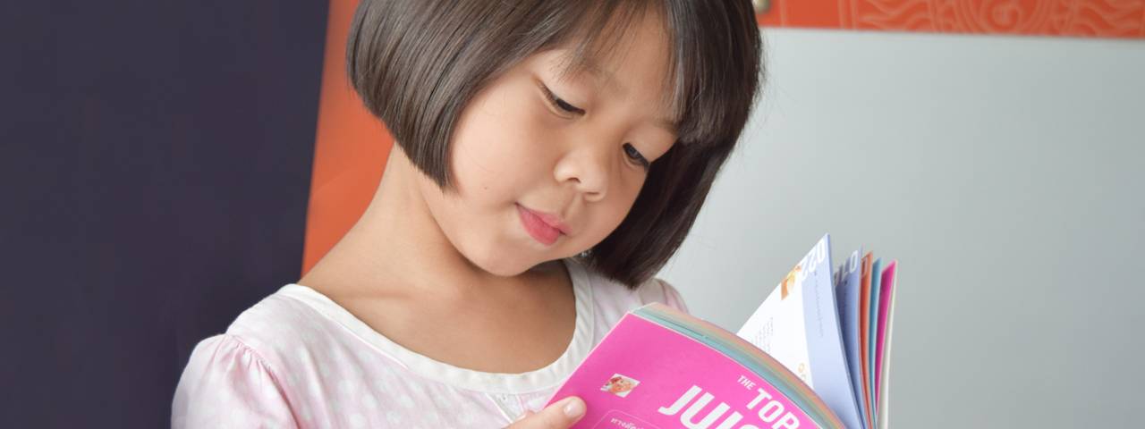 Gril Reading, Showing Importance of Pediatric Eye Care