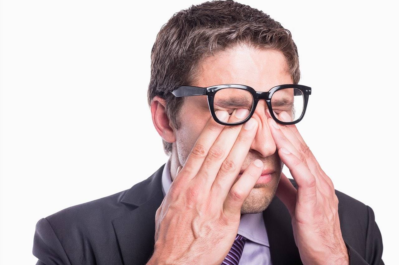 Eye doctor, man rubbing his eyes with eye allergies in Delaware, OH