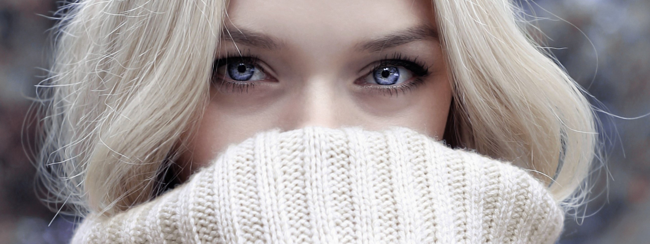 woman with blue eyes, behind sweater