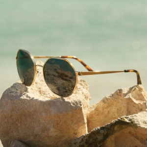 pair of michael kors sunglasses on a rock