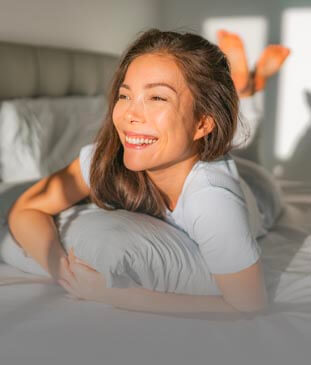 Woman smiling on a Bed