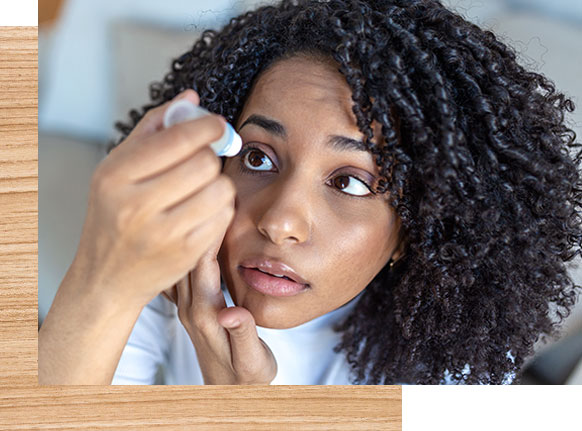 african american woman taking eye drops