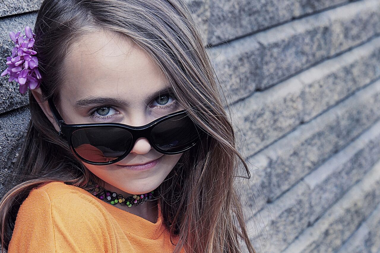 Girl wearing sunglasses after orthokeratology
