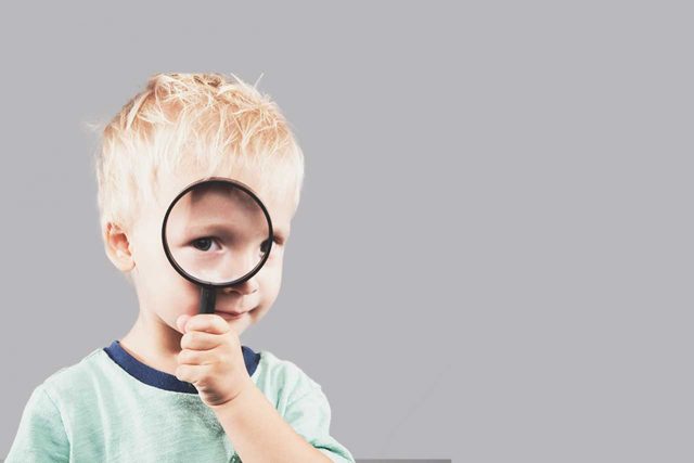 liitle boy with magnifying glass