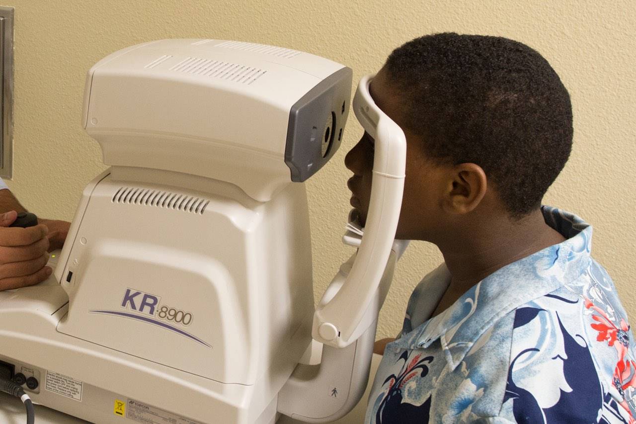 Child having eye exam with eye care technology