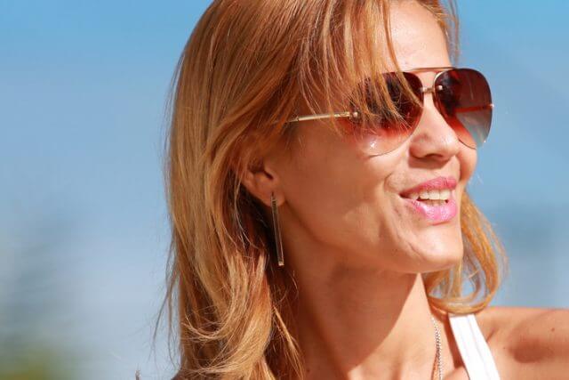 Woman wearing sunglasses, smiling