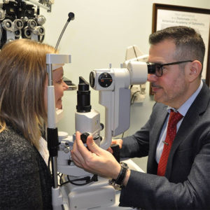 Dr. Randy Charrier taking eye exam of a patient 13 in Houston TX 300x300