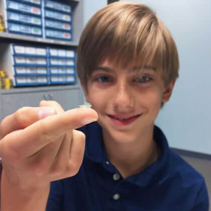 boy holding a contact lens