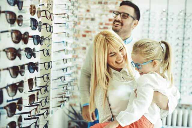 Caucasian Family Trying on Eyeglasses