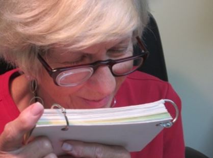 woman reading with low vision assistance device