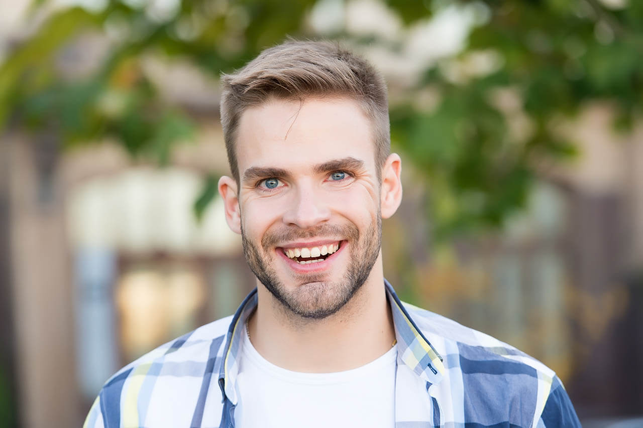 Smiling man with scleral contact lenses