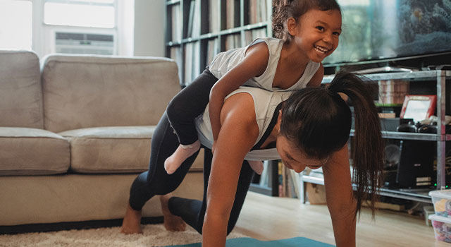 woman and her daughter exercising at home