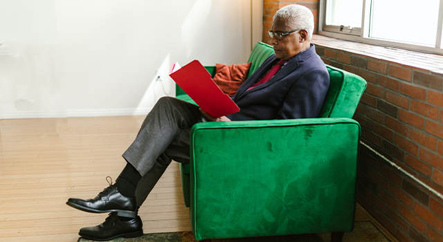 Elderly Man With Low Vision Reading a Book