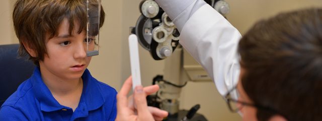 Optometrist, little boy at an eye exam in St. Louis, MO