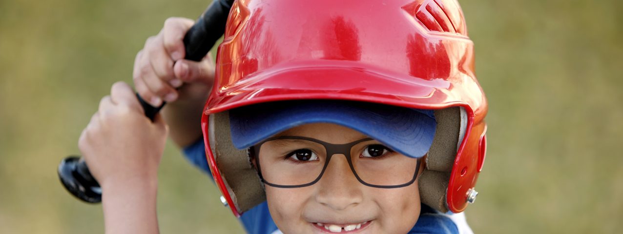 Cute little boy wearing glasses, playing baseball