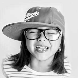 Happy girl, wearing cap and eyeglasses