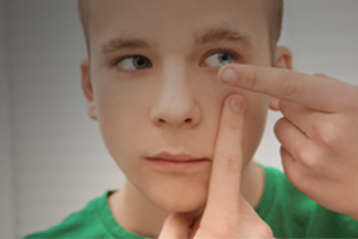 eye exam, Teen Boy putting his Contact Lens in Roselle, IL