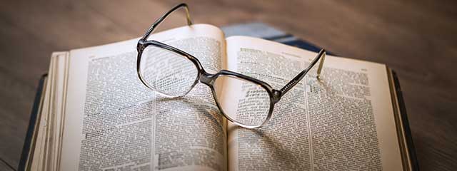 Pair of eyeglasses on a book