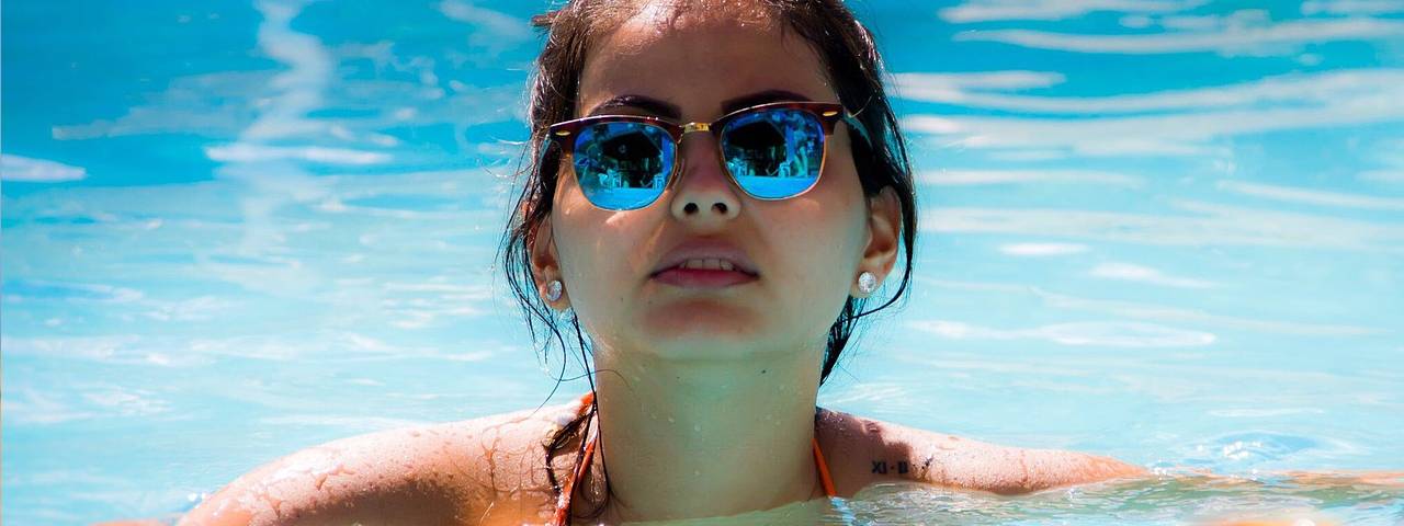 Eye doctor, girl wearing sunglasses in the pool in North Miami Beach, FL