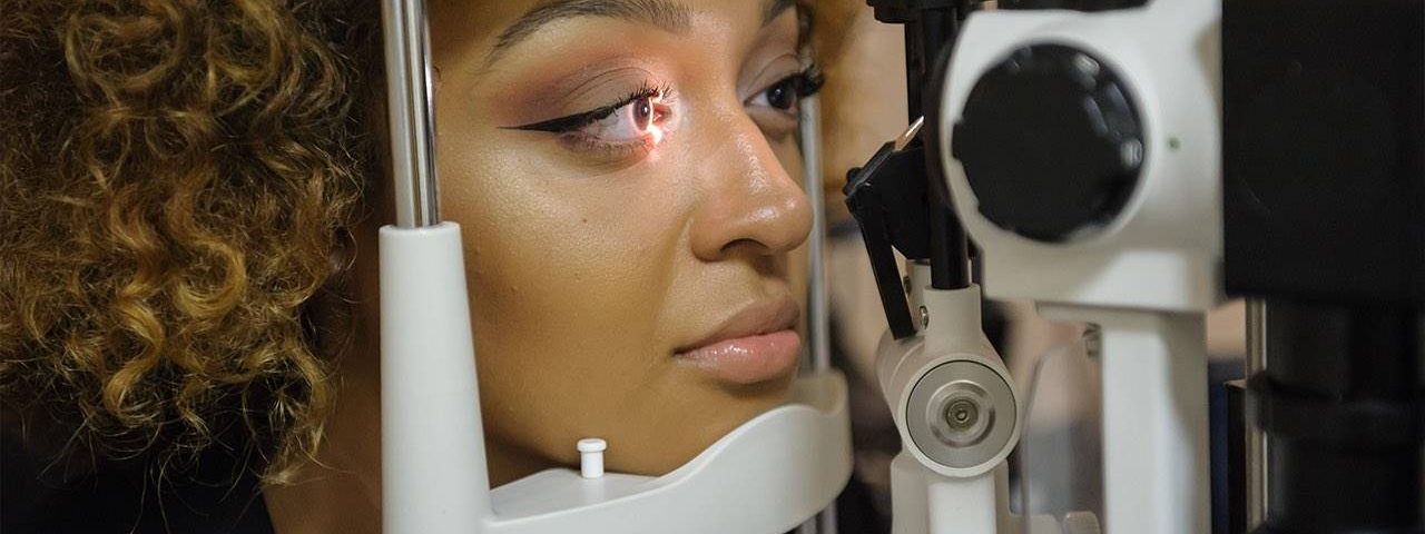 Eye doctor, girl receiving eye exam for contact lens in North Miami Beach, Florida
