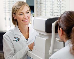 Optometrist giving patient eye exam