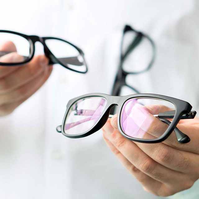Optician Holding Glasses