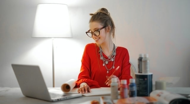 happy woman wearing eyeglasses working from home 640×350