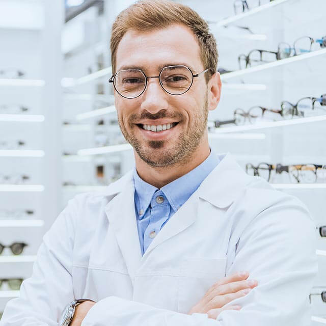 Portrait Of Smiling Professional Optometrist In Glasses Posing W