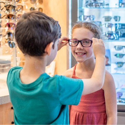 children trying on eyeglasses