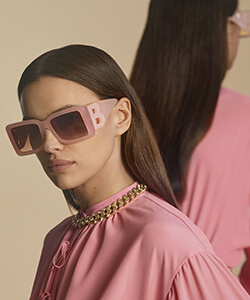lady in pink wearing burberry sunglasses