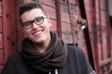 Young man wearing glasses, smiling