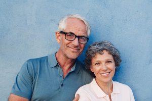 Senior couple smiling, male wearing glasses