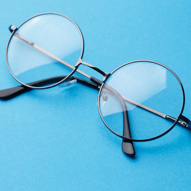 pair of eyeglasses on a light blue background