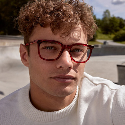 man wearing red eco eyeglasses