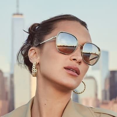 woman wearing gold tinted michael kors sunglasses.jpg