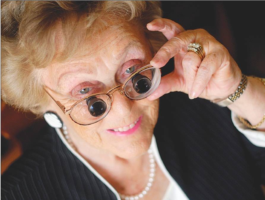 Elderly woman using bioptic telescopes