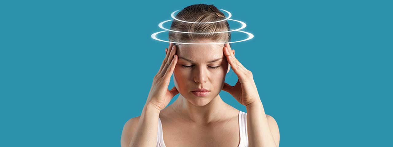 Woman dealing with dizziness and headaches