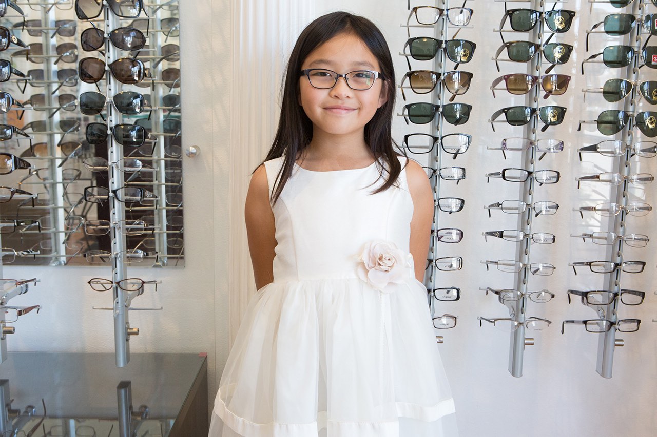 girl white dress new glasses display wall