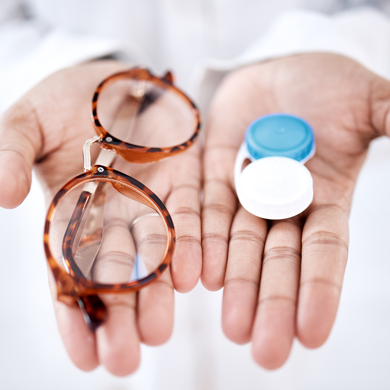 Eye care, choice with glasses or contact lenses in hands, closeup and vision with healthcare for eyes.