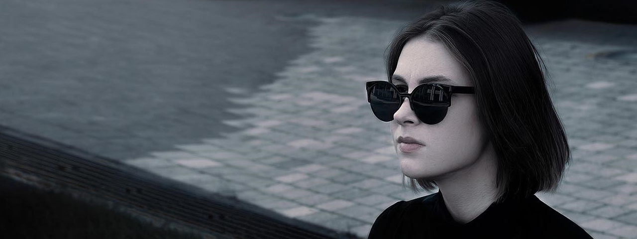 woman modeling black sunglasses