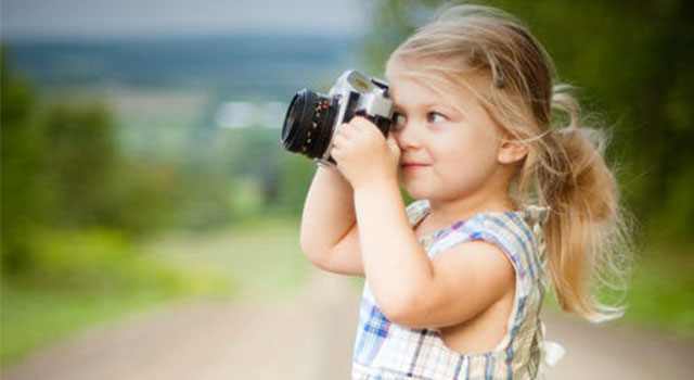 child taking photograph