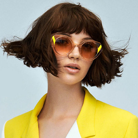 woman wearing face a face eyewear and yellow jacket