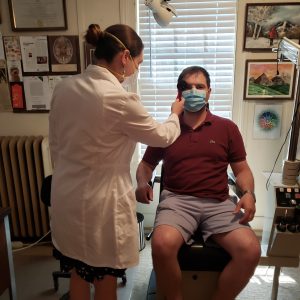 our eye doctor and patient wearing a mask and protective gear
