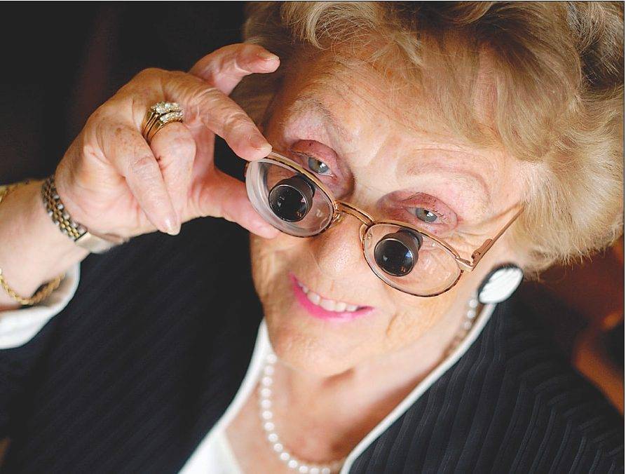 Older woman wearing low vision device