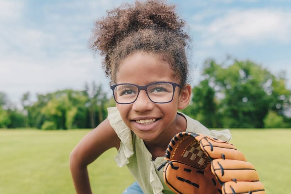 young girl eyeglasses baseball glove