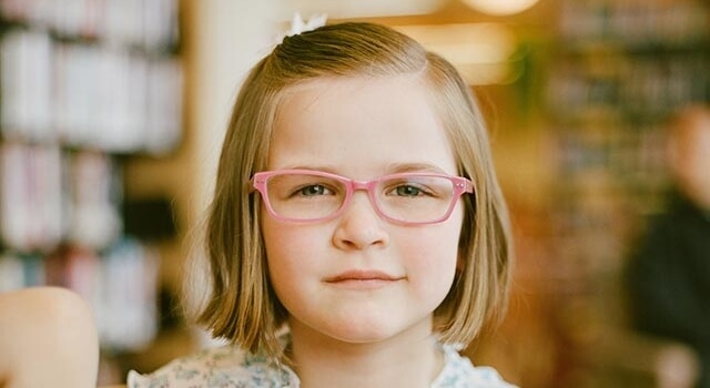 girl wearing pink eyeglasses