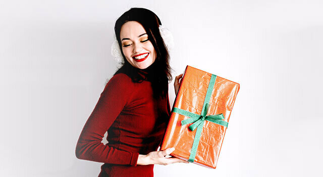 woman in holiday dress w gift.jpg