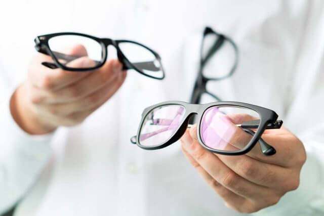 optician holding eyeglasses