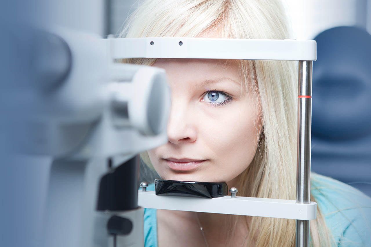 optometry concept pretty young woman having her eyes examined