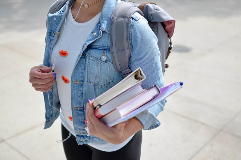 girl carrying school books